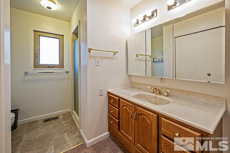 12005 Broken Hill Road Reno, NV 89511 - Photo 13 of 20 a bathroom with a sink a vanity and a mirror