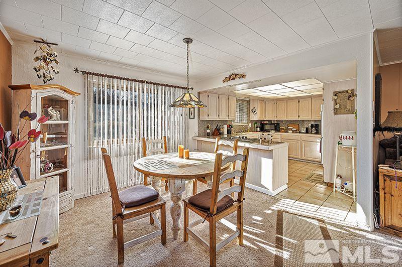 12005 Broken Hill Road Reno, NV 89511 - Photo 5 of 20 a view of a dining room with furniture and a kitchen