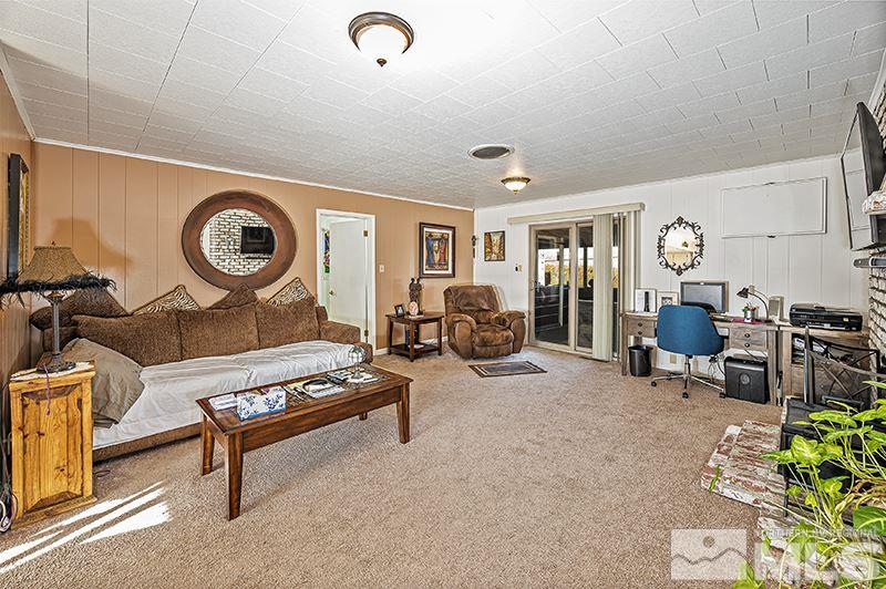 12005 Broken Hill Road Reno, NV 89511 - Photo 6 of 20 a living room with furniture a clock on wall and a window