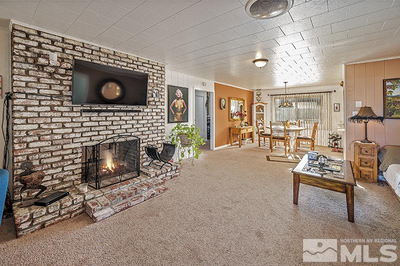 12005 Broken Hill Road Reno, NV 89511 - Photo 7 of 20 a living room with furniture a flat screen tv and a fireplace