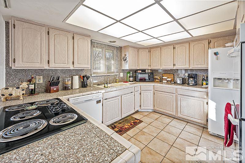 12005 Broken Hill Road Reno, NV 89511 - Photo 8 of 20 a kitchen with a stove a sink and a microwave