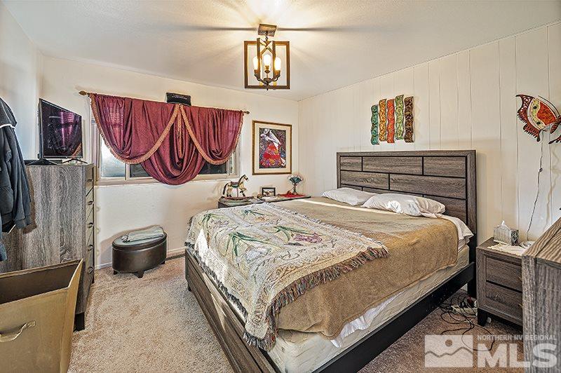 12005 Broken Hill Road Reno, NV 89511 - Photo 10 of 20 a bedroom with a bed and a chair with the view of bathroom