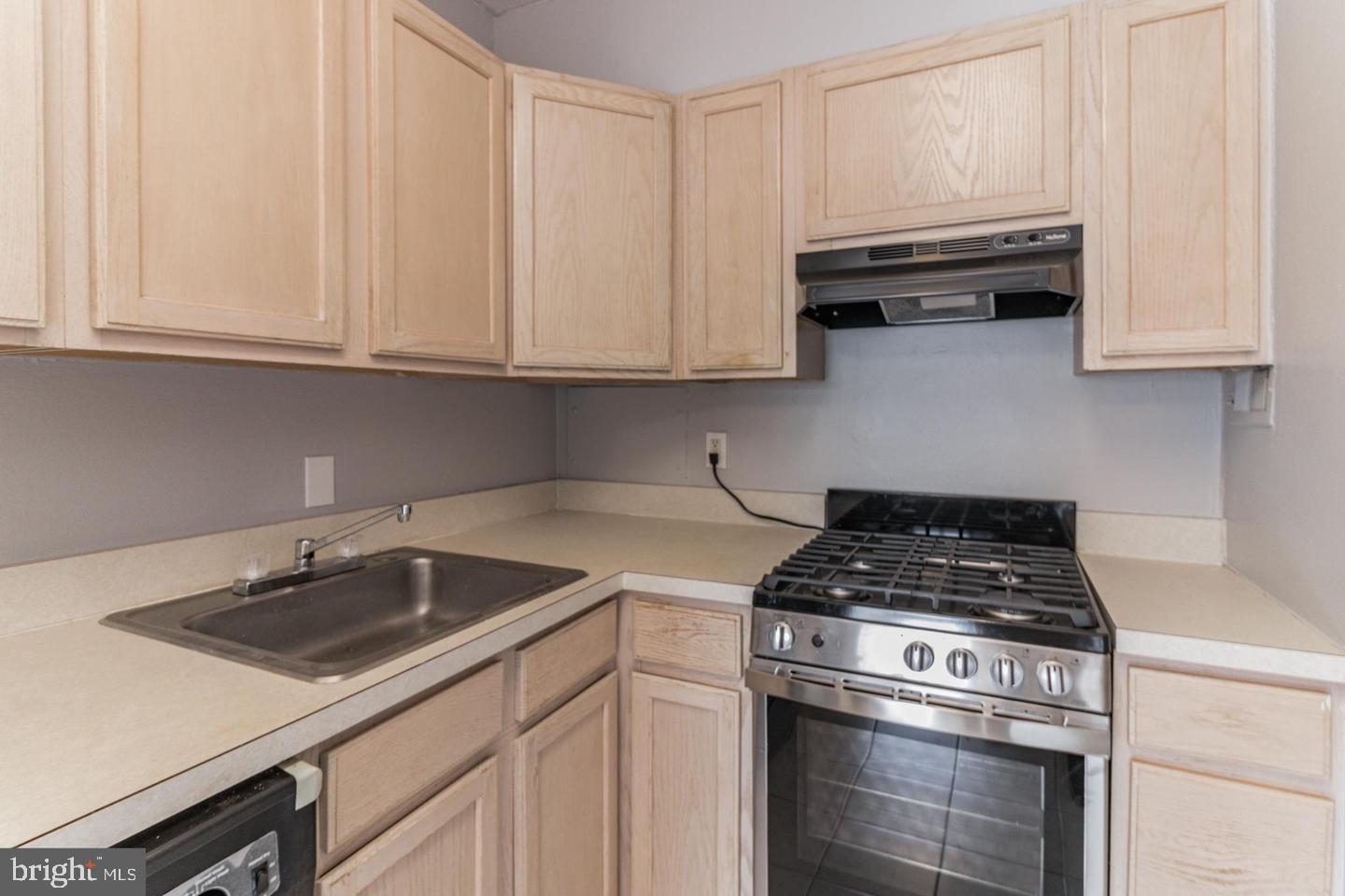 2101-17 Chestnut Street, Unit 1608 Philadelphia, PA 19103 - Photo 13 of 28 a kitchen with white cabinets and a stove top oven