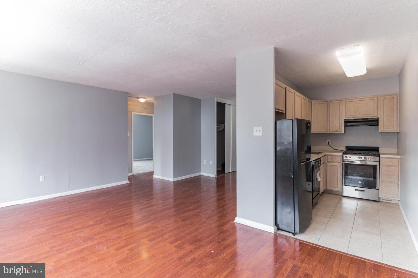 2101-17 Chestnut Street, Unit 1608 Philadelphia, PA 19103 - Photo 8 of 28 a view of kitchen with refrigerator and wooden floor