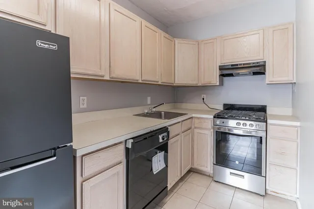a kitchen with stainless steel appliances granite countertop a stove and a refrigerator