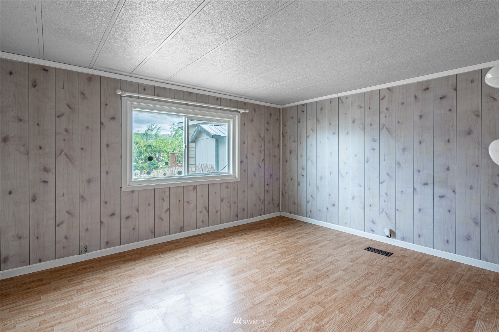 35 Apple Acres Road, Unit 112 Chelan, WA 98816 - Photo 13 of 35 a view of an empty room with wooden floor and a window