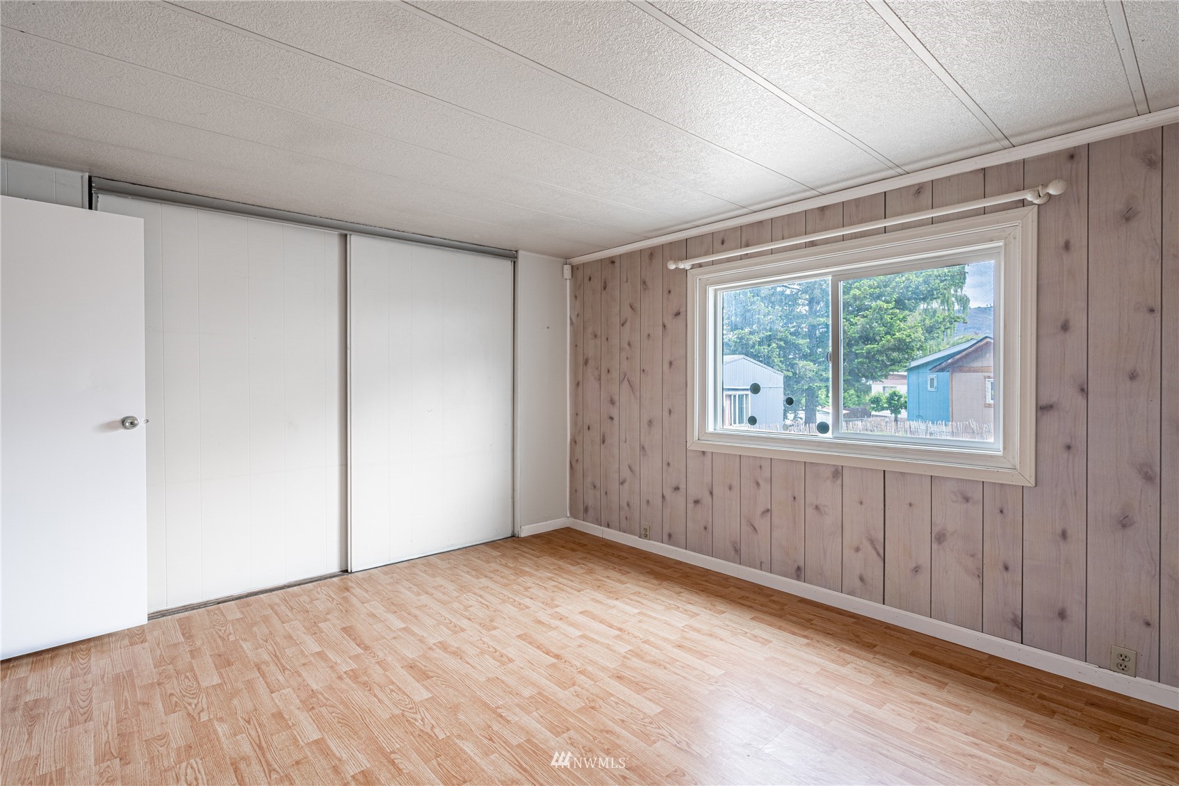 35 Apple Acres Road, Unit 112 Chelan, WA 98816 - Photo 14 of 35 a view of an empty room with wooden floor and a window