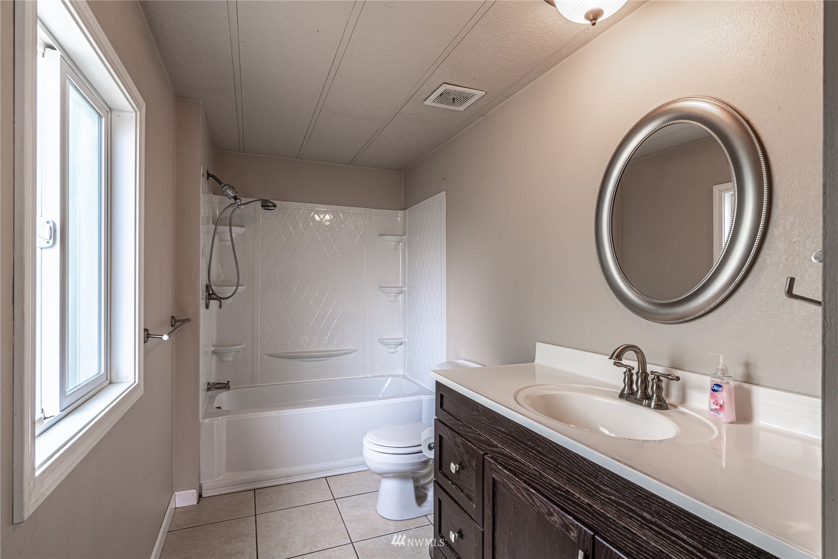 35 Apple Acres Road, Unit 112 Chelan, WA 98816 - Photo 16 of 35 a bathroom with a granite countertop toilet sink and a mirror