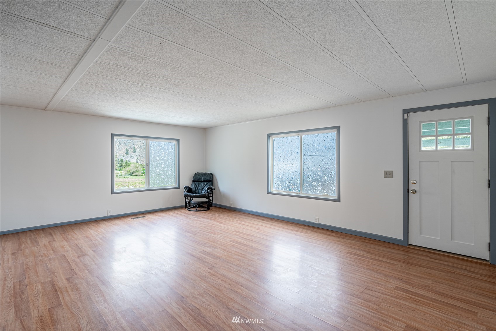 35 Apple Acres Road, Unit 112 Chelan, WA 98816 - Photo 2 of 35 a view of an empty room with wooden floor and a window