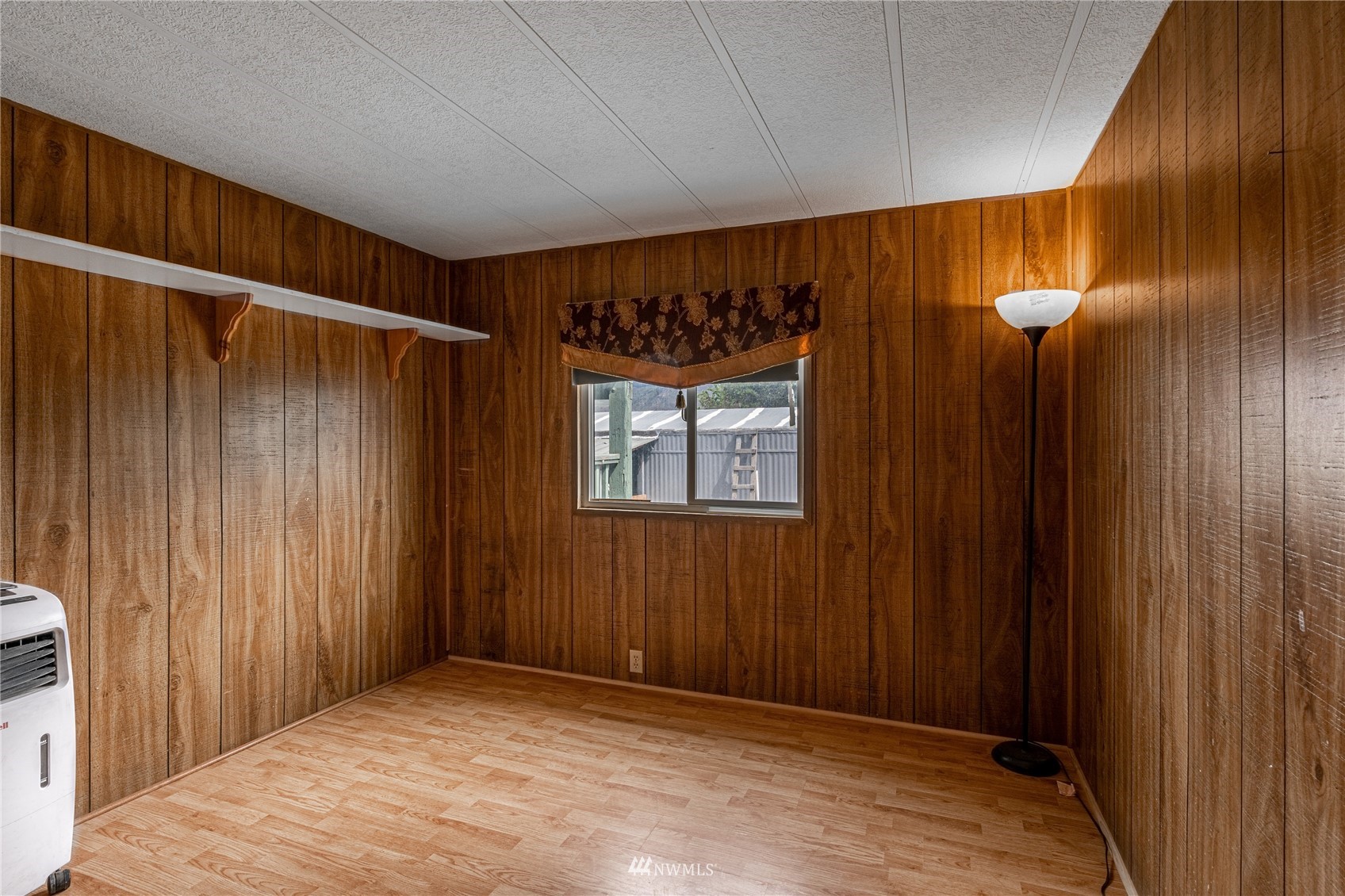 35 Apple Acres Road, Unit 112 Chelan, WA 98816 - Photo 21 of 35 a view of an empty room with wooden floor and a window
