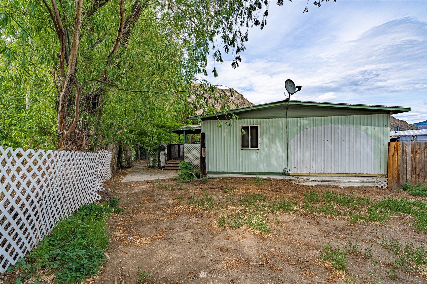 35 Apple Acres Road, Unit 112 Chelan, WA 98816 - Photo 28 of 35 a house with trees in the background