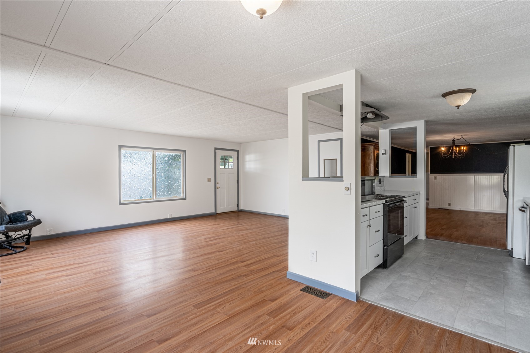 35 Apple Acres Road, Unit 112 Chelan, WA 98816 - Photo 5 of 35 an empty room with wooden floor and windows