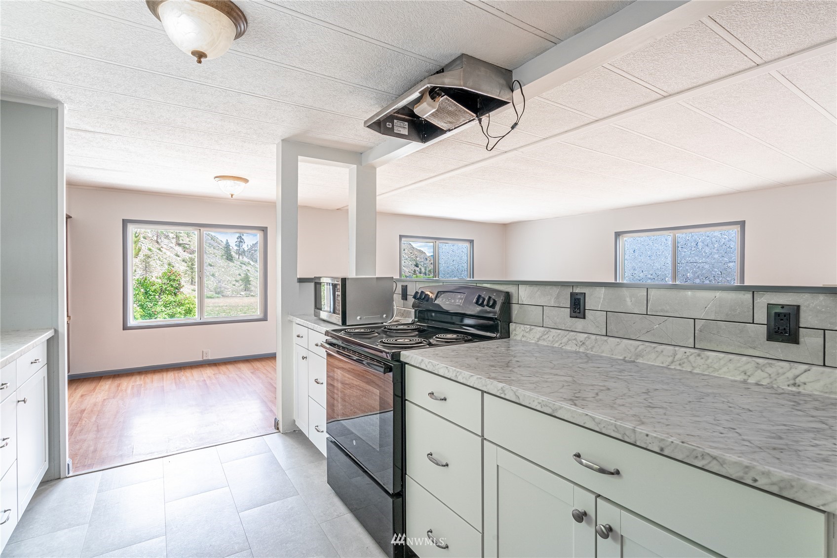 35 Apple Acres Road, Unit 112 Chelan, WA 98816 - Photo 8 of 35 a kitchen with stainless steel appliances granite countertop a sink a stove and cabinets