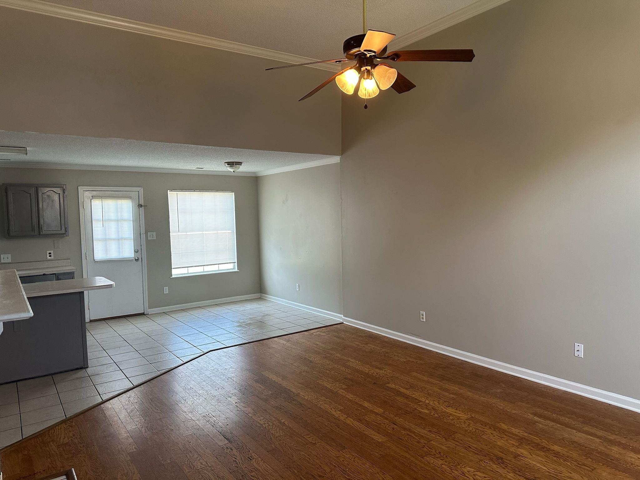 10007 Cameron Ridge Trail Memphis, TN 38016 - Photo 4 of 16 Unfurnished living room with ornamental molding, ceiling fan, and light wood-type flooring