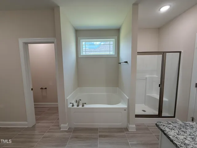 a bathroom with a bathtub and a shower