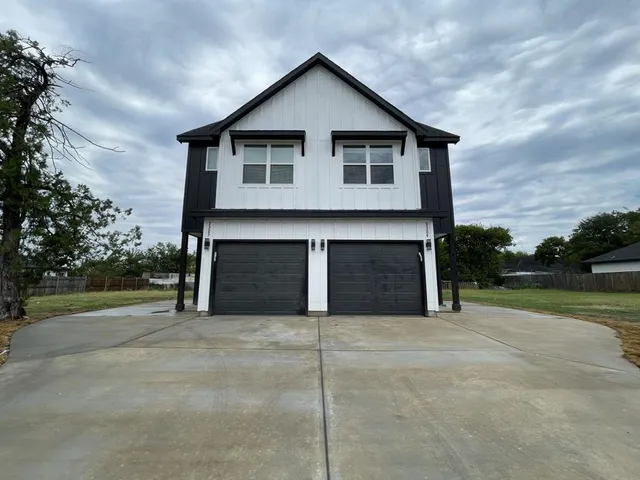 a view of a house with a yard and garage