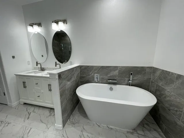 a spacious bathroom with a bathtub and a mirror