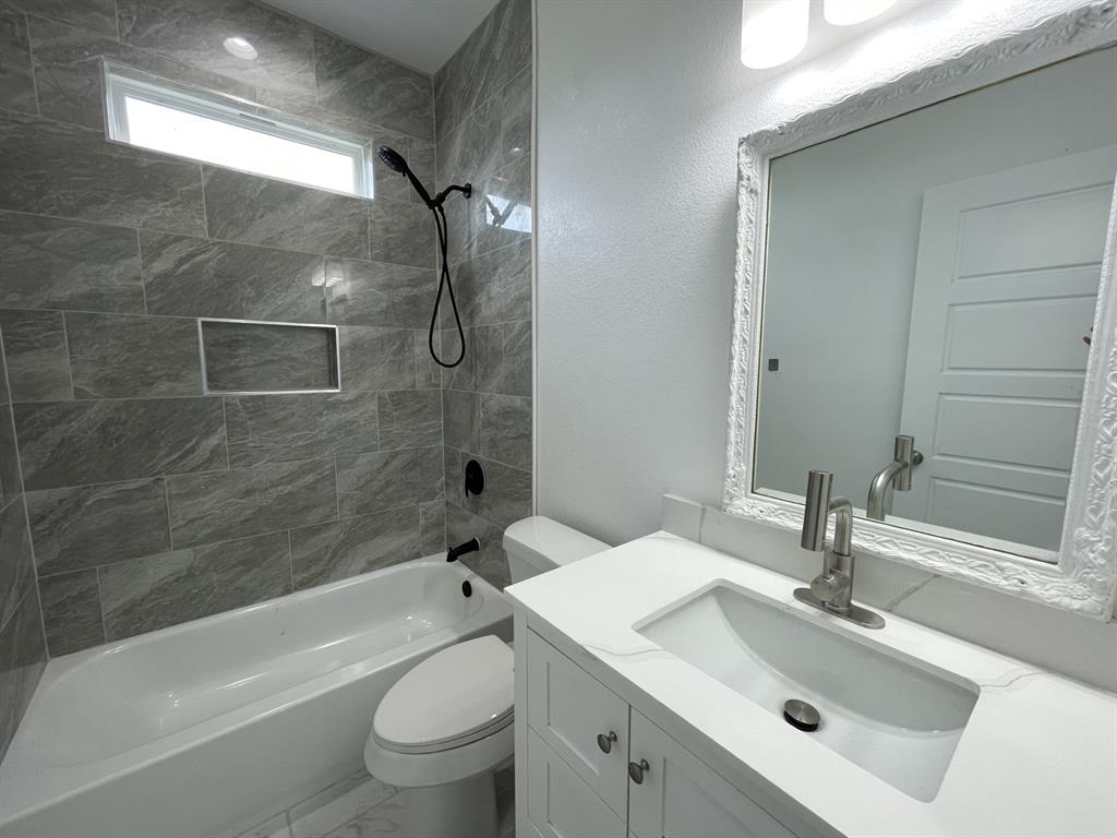 3309 Collin Street Fort Worth, TX 76119 - Photo 14 of 15 a bathroom with a sink toilet and shower