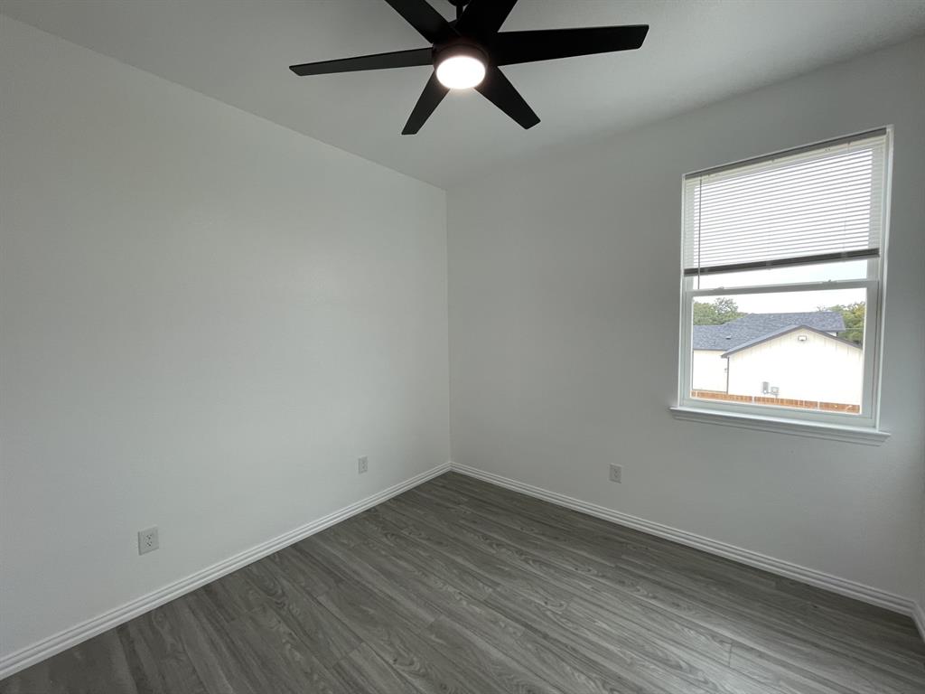 3309 Collin Street Fort Worth, TX 76119 - Photo 15 of 15 an empty room with a window and a ceiling fan