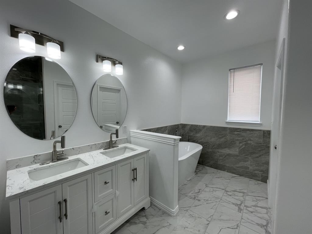 3309 Collin Street Fort Worth, TX 76119 - Photo 10 of 15 a bathroom with a double vanity sink and a mirror