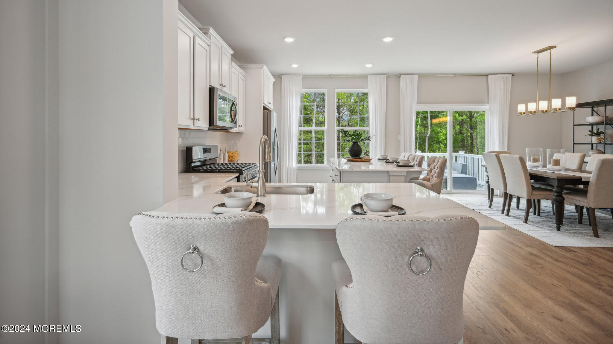 16 Rothbury Court Tinton Falls, NJ 07753 - Photo 18 of 43 a living room with furniture a large window and dining table