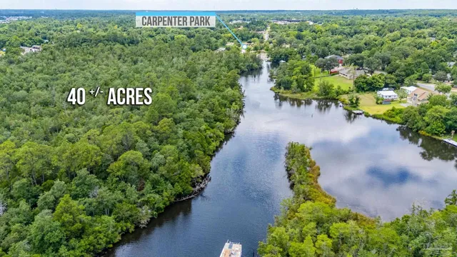 an aerial view of a residential houses with outdoor space and street view