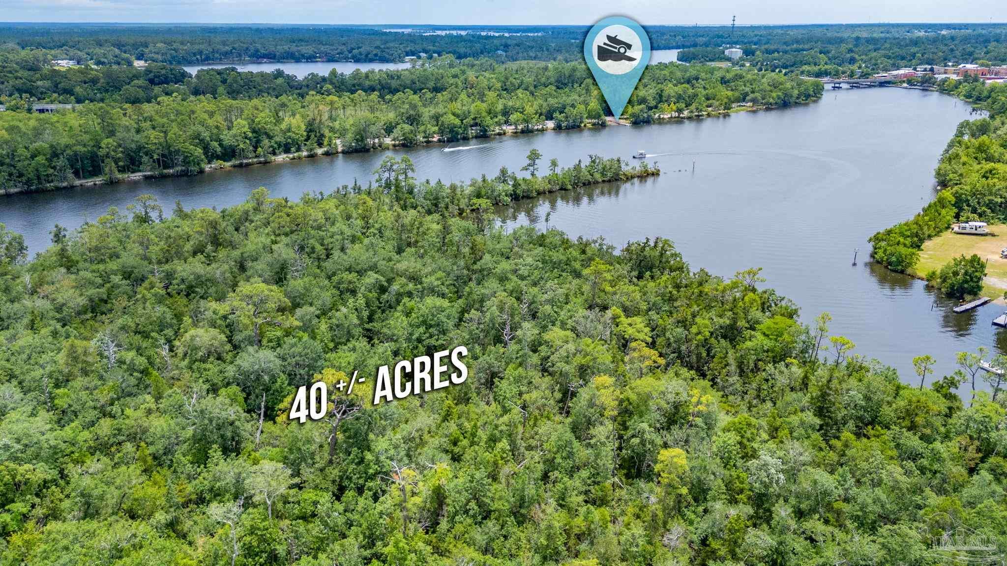0 Broad Street Milton, FL 32570 - Photo 7 of 36 an aerial view of a house with outdoor space and lake view