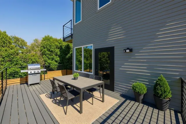 a view of a patio with table and chairs potted plants with wooden floor