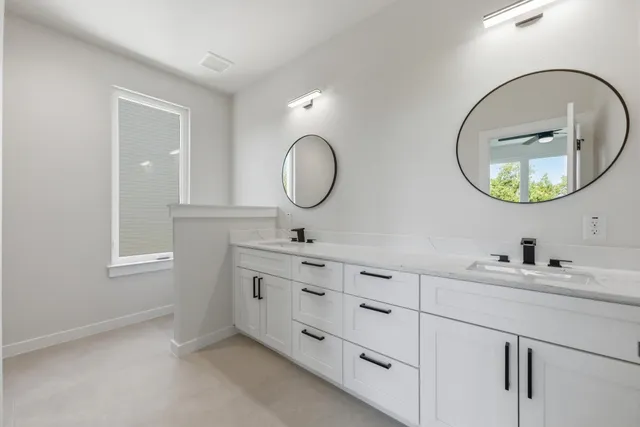 a bathroom with a double vanity sink and a mirror