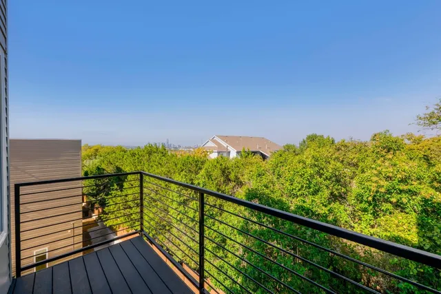 a view of a balcony with wooden floor