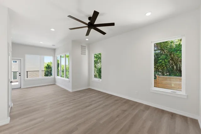 a view of a livingroom with a ceiling fan and window
