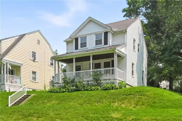 a view of an house with backyard space and garden