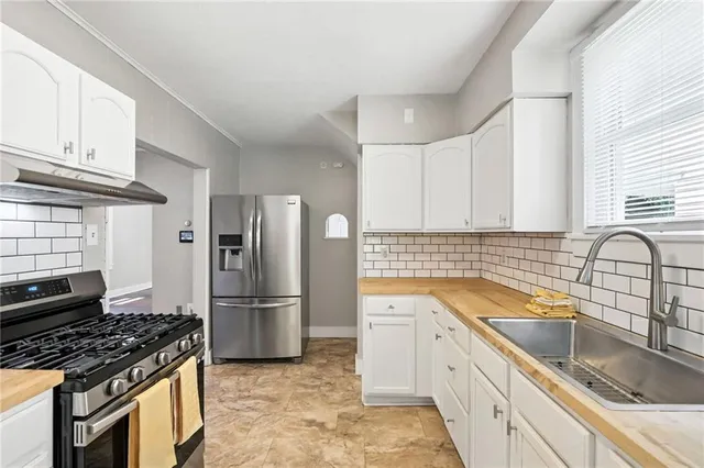 a kitchen with a sink stove and refrigerator