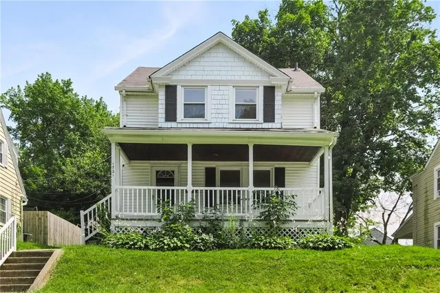 a front view of a house with a small yard