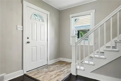 a view of entryway and hall with wooden floor