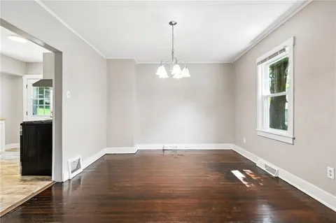 a view of a room with wooden floor and windows