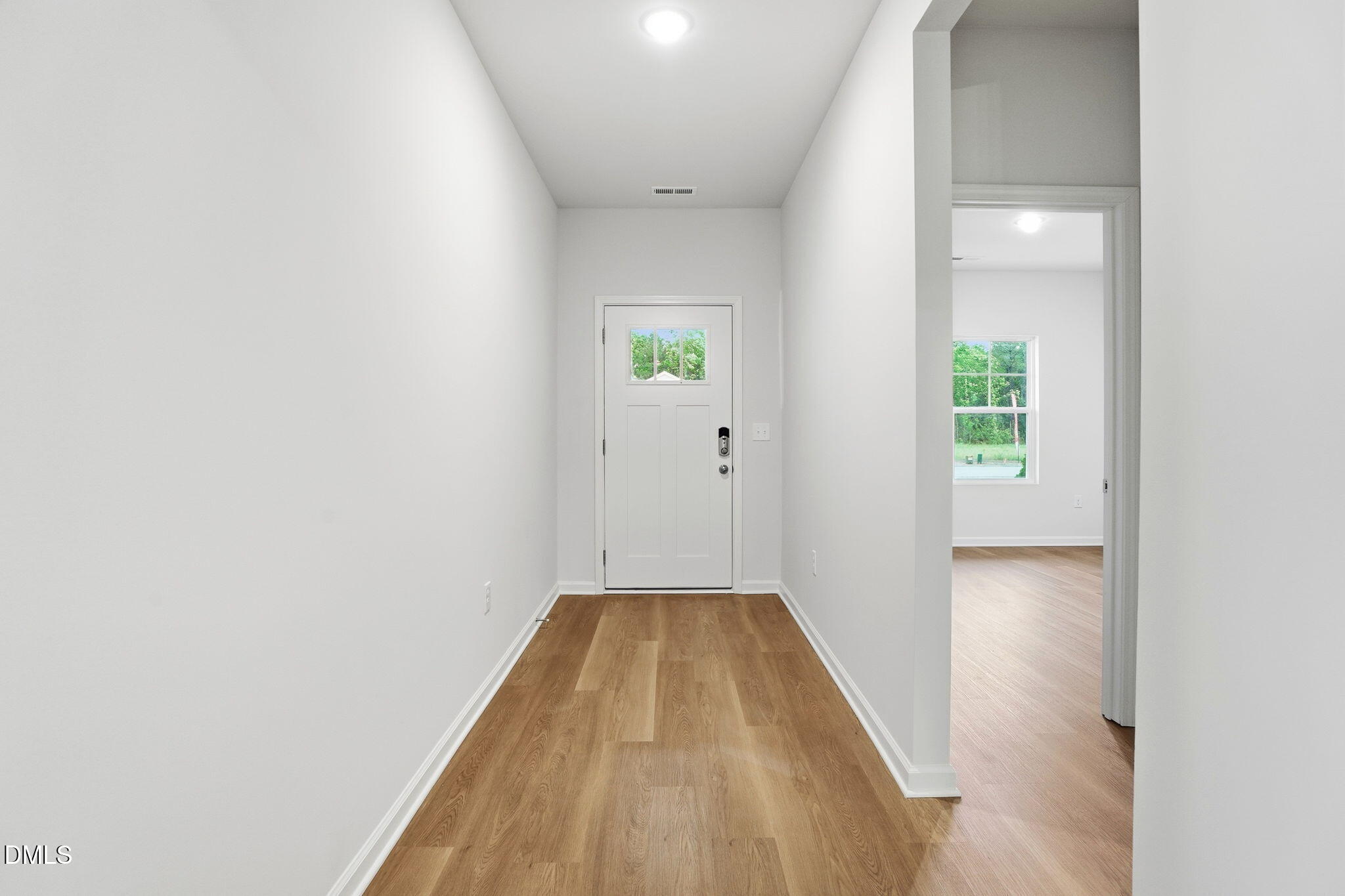 9019 Phoenix Court Spring Hope, NC 27882 - Photo 29 of 34 a view of a hallway with wooden floor and a bathroom