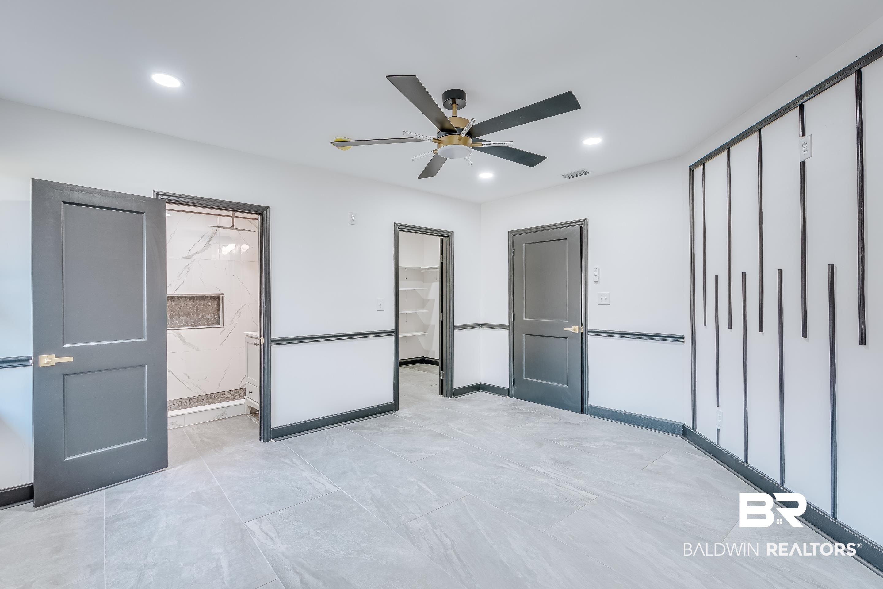 1190 Military Road Mount Vernon, AL 36560 - Photo 25 of 47 Unfurnished bedroom with ensuite bathroom, a spacious closet, a ceiling fan, and recessed lighting