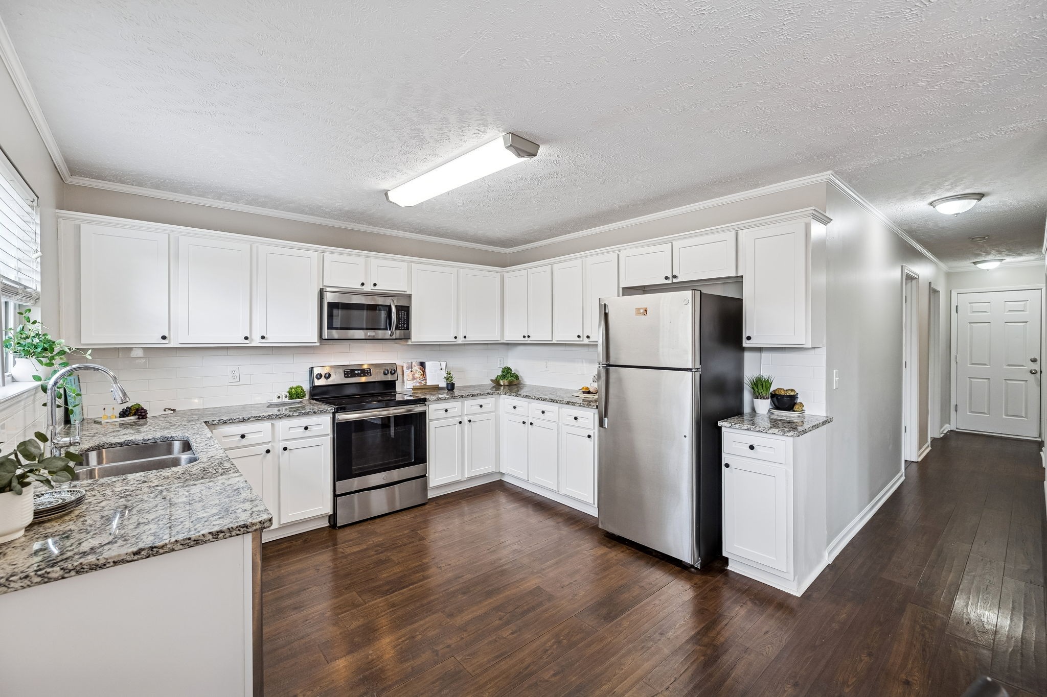 5807 Roxbury Drive Murfreesboro, TN 37128 - Photo 26 of 99 a kitchen with a refrigerator a stove top oven a sink and cabinets