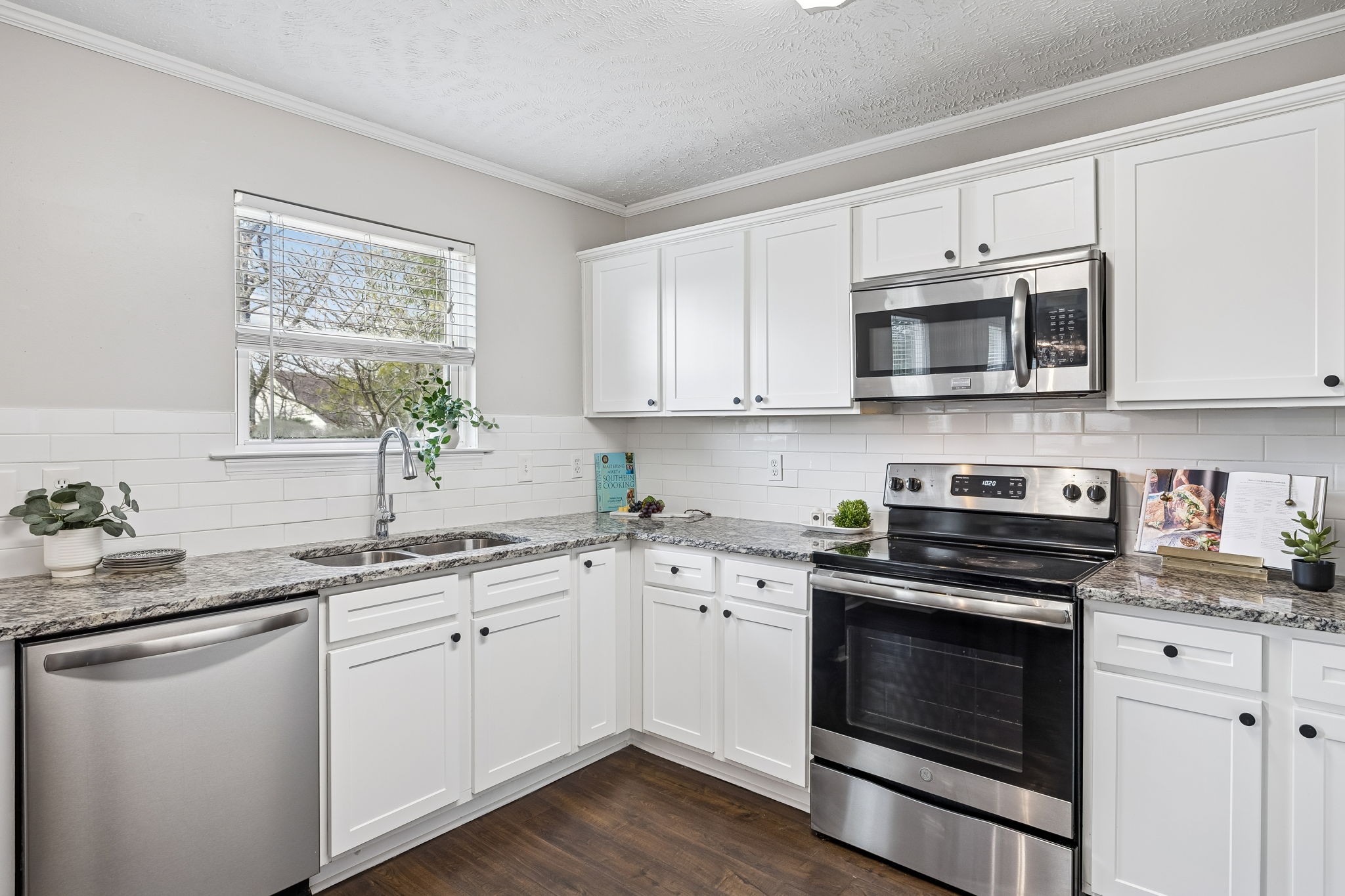 5807 Roxbury Drive Murfreesboro, TN 37128 - Photo 28 of 99 a kitchen with stainless steel appliances granite countertop white cabinets a sink a stove a microwave and wooden floors