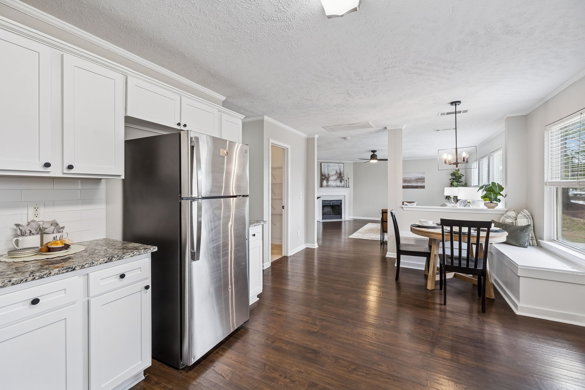5807 Roxbury Drive Murfreesboro, TN 37128 - Photo 29 of 99 a kitchen with stainless steel appliances granite countertop a refrigerator a stove a dining table and chairs with wooden floor