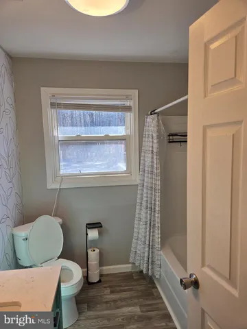 a bathroom with a toilet a sink and a shower