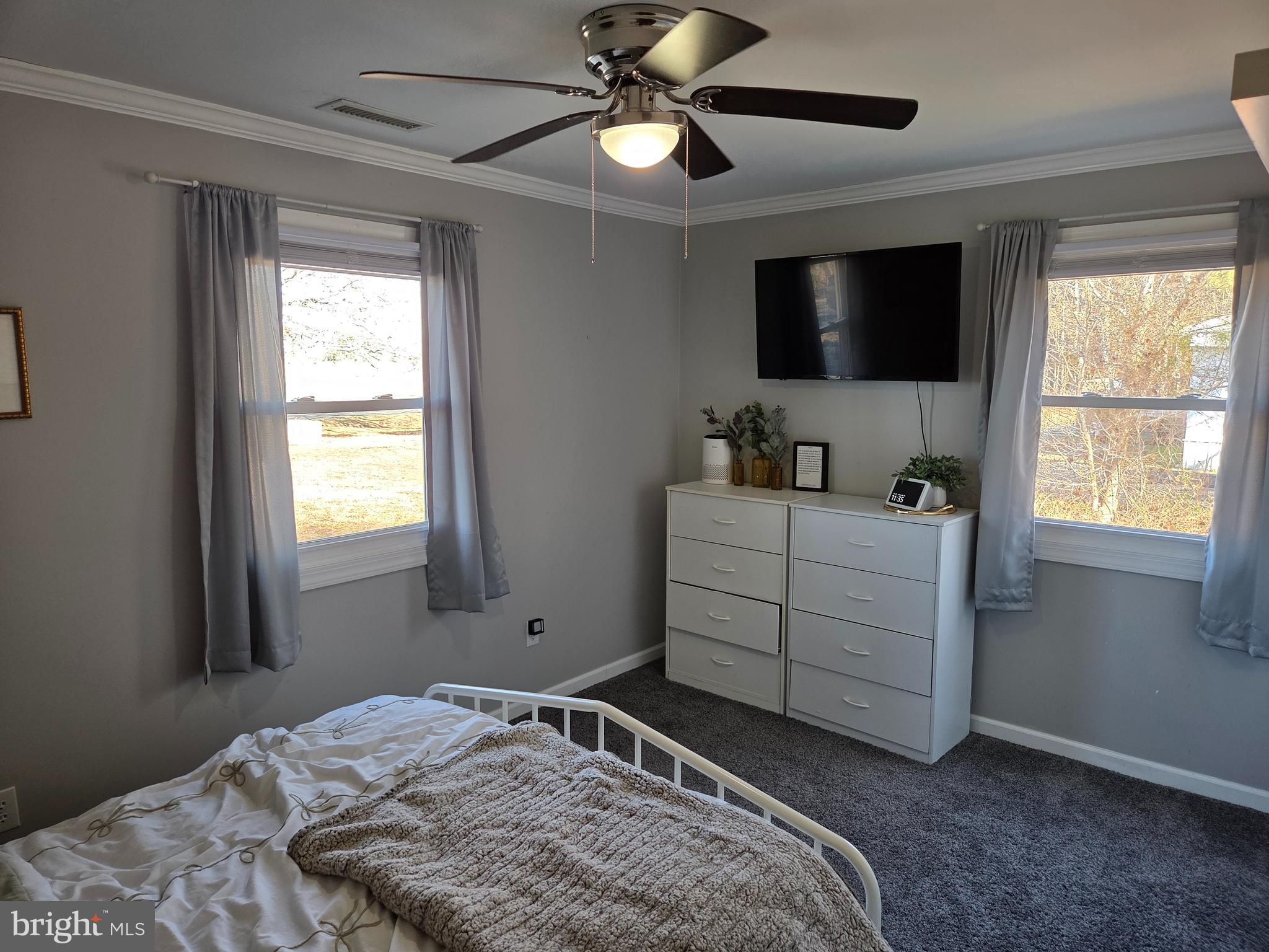 6327 Charles Cannon Road Marion Station, MD 21838 - Photo 16 of 23 a bedroom with a bed and a flat tv screen on dresser