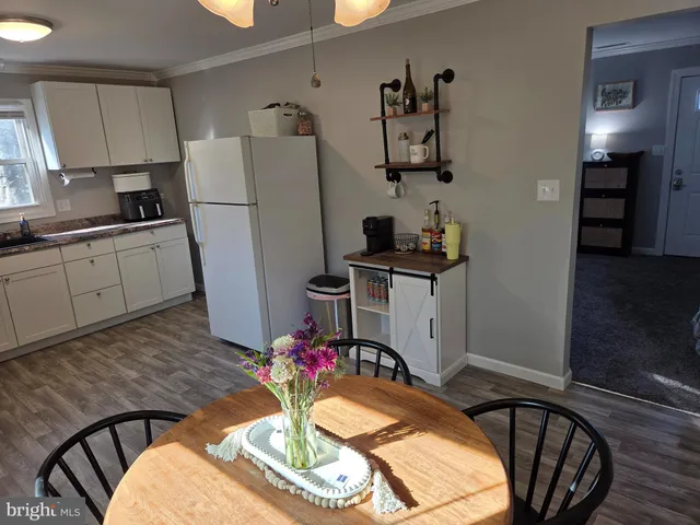 a kitchen with stainless steel appliances granite countertop a refrigerator a stove a sink dishwasher and microwave