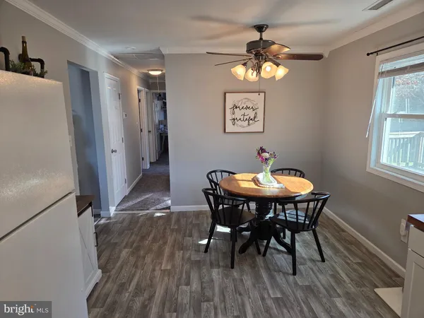 a dining room with furniture a window and a chandelier