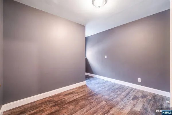 a bathroom with a granite countertop toilet sink and mirror