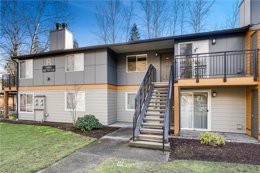 10831 Northeast 147th Lane, Unit R201 Bothell, WA 98011 - Photo 1 of 17 a front view of a house with a garden