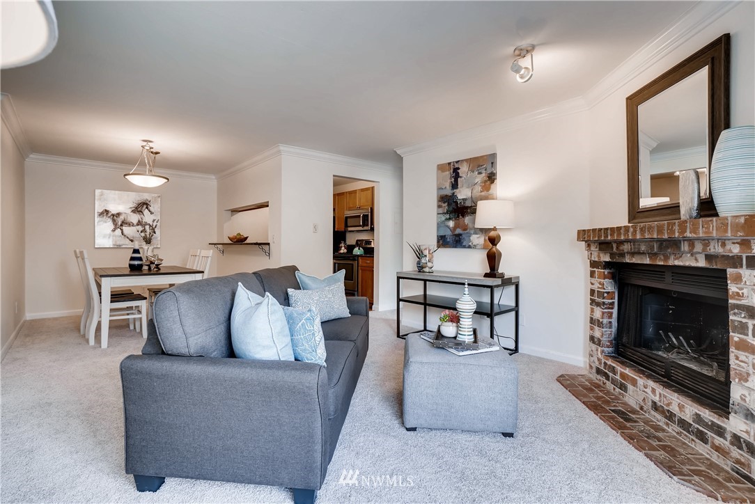 10831 Northeast 147th Lane, Unit R201 Bothell, WA 98011 - Photo 2 of 17 a living room with furniture and a fireplace
