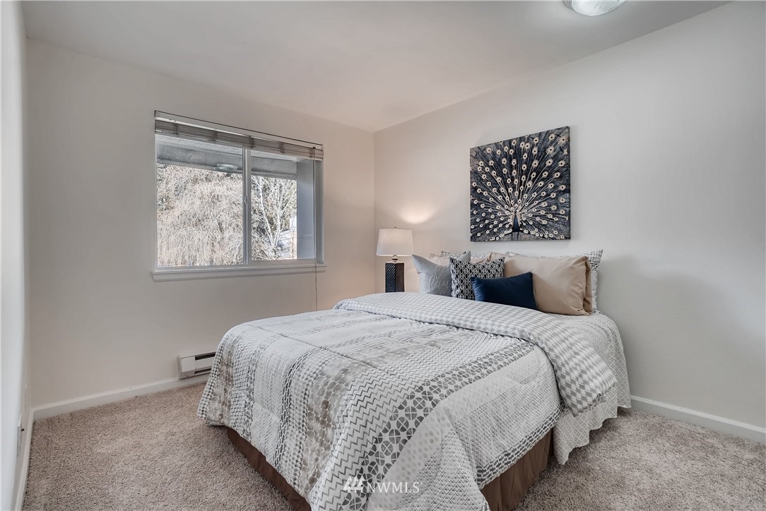 10831 Northeast 147th Lane, Unit R201 Bothell, WA 98011 - Photo 14 of 17 a bedroom with bed and a window