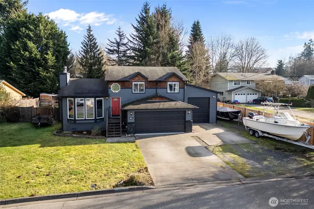 a view of a house with a yard patio and fire pit